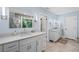 Bright bathroom featuring double vanity with quartz countertops, modern fixtures, and stylish tile flooring at 7750 Landowne Dr, Atlanta, GA 30350