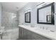 Stylish bathroom with modern fixtures, double vanity, and walk-in shower with geometric tile design at 7750 Landowne Dr, Atlanta, GA 30350