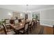 Spacious dining room featuring a large mirror, elegant lighting, and seating for eight at 7750 Landowne Dr, Atlanta, GA 30350