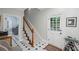 Welcoming entryway with tile floors, staircase, and white-painted door with window at 7750 Landowne Dr, Atlanta, GA 30350