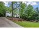 Well-maintained home boasts a long driveway and vibrant green lawn at 7750 Landowne Dr, Atlanta, GA 30350