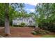Elegant two-story home featuring a well-manicured lawn and professional landscaping at 7750 Landowne Dr, Atlanta, GA 30350