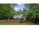 Charming two-story home with lush, mature trees adding curb appeal and privacy at 7750 Landowne Dr, Atlanta, GA 30350