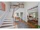 Bright foyer with a hardwood floor, staircase, and view into the formal living room at 7750 Landowne Dr, Atlanta, GA 30350