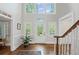 Spacious foyer featuring hardwood floors, staircase, and a stylish glass front door at 7750 Landowne Dr, Atlanta, GA 30350
