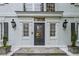 Elegant front door with decorative glass, sidelights, and black lanterns at 7750 Landowne Dr, Atlanta, GA 30350