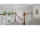 Upstairs landing with white railings overlooking the foyer and front door at 7750 Landowne Dr, Atlanta, GA 30350