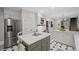 Updated kitchen featuring white cabinets, an island with seating, and stainless steel refrigerator at 7750 Landowne Dr, Atlanta, GA 30350