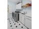 Well-appointed laundry room with updated appliances, sink, countertop, and storage cabinets at 7750 Landowne Dr, Atlanta, GA 30350