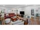 Comfortable living room with a plush red sofa, area rug, and white paneled walls at 7750 Landowne Dr, Atlanta, GA 30350