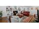 Elegant living room featuring a fireplace, built-in shelves, and a classic red leather sofa at 7750 Landowne Dr, Atlanta, GA 30350