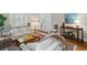 Bright living room with white sofas, area rug, console table with décor, and open doorway at 7750 Landowne Dr, Atlanta, GA 30350
