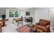 Comfortable home office featuring a work desk, area rug, and sitting area for relaxation and focus at 7750 Landowne Dr, Atlanta, GA 30350