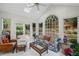 Bright sunroom featuring tile flooring, vaulted ceiling, large windows, and comfortable seating arrangement at 7750 Landowne Dr, Atlanta, GA 30350