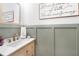 Stylish bathroom features a wood vanity, gold hardware, and elegant wainscoting at 1388 Ben Park Way, Grayson, GA 30017