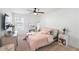 Bright bedroom featuring a ceiling fan, natural light, and a cozy bed with pink bedding at 1388 Ben Park Way, Grayson, GA 30017