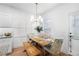 Cozy dining area featuring a wooden table, upholstered chairs, and a modern chandelier at 1388 Ben Park Way, Grayson, GA 30017
