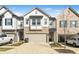 Charming townhome with a mix of stone and siding, a two-car garage, and a well-maintained driveway at 1388 Ben Park Way, Grayson, GA 30017