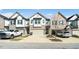 Attractive townhomes featuring a two-car garage and a mix of stone and siding exterior at 1388 Ben Park Way, Grayson, GA 30017