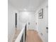 Bright hallway features hardwood floors and white walls, creating a modern, clean aesthetic at 1388 Ben Park Way, Grayson, GA 30017