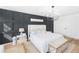 Relaxing main bedroom boasts a decorative accent wall, chandelier, and neutral decor at 1388 Ben Park Way, Grayson, GA 30017