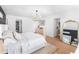 Bright main bedroom features an accent wall, chandelier, and hardwood flooring at 1388 Ben Park Way, Grayson, GA 30017