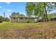 Exterior backyard featuring a shed and mature trees providing shade, set on a spacious grassy lot at 4781 Lincoln Ne Dr, Kennesaw, GA 30144