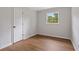 Bedroom with wood-look floors and natural light from a window at 4781 Lincoln Ne Dr, Kennesaw, GA 30144
