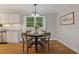 Charming dining area featuring a modern chandelier and a view of the trees at 4781 Lincoln Ne Dr, Kennesaw, GA 30144