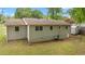 Rear exterior view of the home with neutral siding, windows, and a well-maintained yard at 4781 Lincoln Ne Dr, Kennesaw, GA 30144