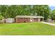 Traditional brick home with green lawn, storage shed, and white trim at 4781 Lincoln Ne Dr, Kennesaw, GA 30144