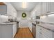 Galley kitchen featuring white cabinets, stainless steel appliances, and stone counters at 4781 Lincoln Ne Dr, Kennesaw, GA 30144