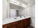 Bathroom features double sinks, large mirror and white painted doors at 1156 Whisper Cove Dr, Buford, GA 30518