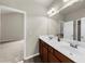 Bathroom features double sinks, large mirror and view to a bedroom at 1156 Whisper Cove Dr, Buford, GA 30518