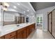 Bright bathroom featuring a double vanity, soaking tub, and glass-enclosed shower at 1156 Whisper Cove Dr, Buford, GA 30518