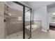 This elegant bathroom offers a separate tiled shower and soaking tub at 1156 Whisper Cove Dr, Buford, GA 30518