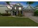 Charming two-story brick front home with a well-manicured lawn and attached two car garage at 1156 Whisper Cove Dr, Buford, GA 30518