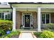 Inviting front porch with brick accents and decorative wreath on the front door at 1156 Whisper Cove Dr, Buford, GA 30518
