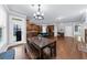 Bright kitchen and living area with wood cabinets, granite counters, island and hardwood floors at 1156 Whisper Cove Dr, Buford, GA 30518