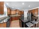 Kitchen featuring granite countertops, stainless steel appliances, a kitchen island, and wood cabinets at 1156 Whisper Cove Dr, Buford, GA 30518