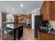 Modern kitchen with granite countertops, stainless steel appliances, an island and wood cabinets at 1156 Whisper Cove Dr, Buford, GA 30518