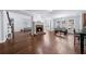 Spacious living room featuring a brick fireplace, hardwood floors, and large windows at 1156 Whisper Cove Dr, Buford, GA 30518