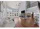 Spacious living room with hardwood floors, fireplace, and ample natural light at 1156 Whisper Cove Dr, Buford, GA 30518