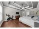 Large main bedroom with a tray ceiling, hardwood floors, a TV, and a view of the ensuite bathroom at 1156 Whisper Cove Dr, Buford, GA 30518