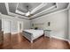 Spacious main bedroom with trey ceiling, hardwood floors, and large windows, providing ample natural light at 1156 Whisper Cove Dr, Buford, GA 30518