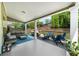 Inviting covered patio with comfortable seating, dining area, and cozy fire pit at 1156 Whisper Cove Dr, Buford, GA 30518