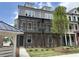 Beautiful multi-level townhome features classic brick and siding exterior, covered porch, and manicured landscaping at 1975 Flying Scotsman Dr # 18, Kennesaw, GA 30144