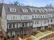 Charming townhome exteriors with neutral siding, covered porches, and well-manicured lawns showcase an inviting community at 1975 Flying Scotsman Dr # 18, Kennesaw, GA 30144