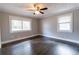 Neutral bedroom with hardwood floors, ceiling fan, and a window at 3844 Davis St, Suwanee, GA 30024