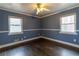 Bedroom with hardwood floors, two windows, and blue accent paint at 3844 Davis St, Suwanee, GA 30024